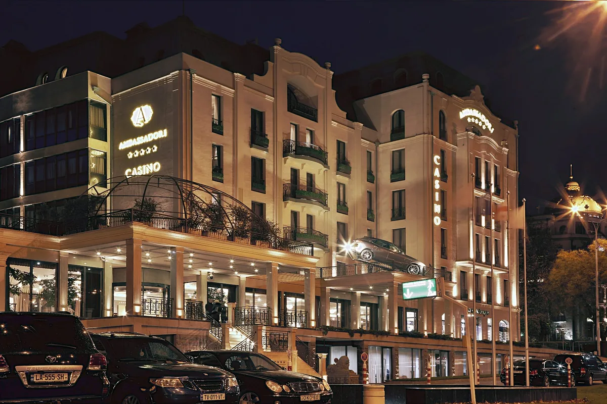Hotel Ambassadori lit up at night on Shavteli Street