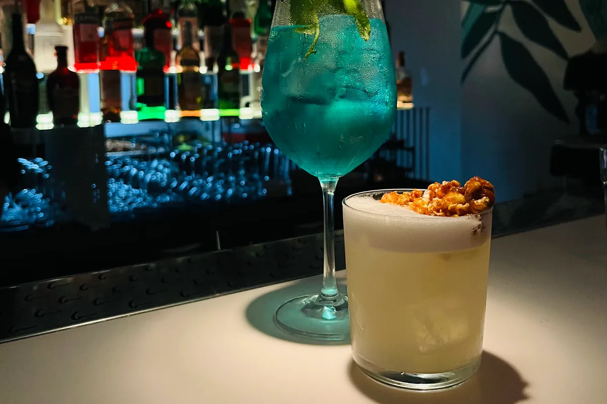 Cocktails on bar counter with back bar background at Barbar'a