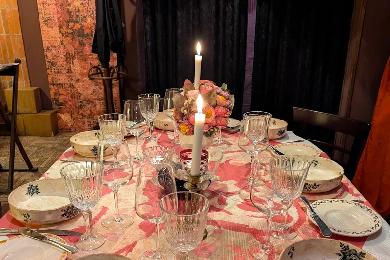 Set dining table with candles and vintage tableware at Barbarestan