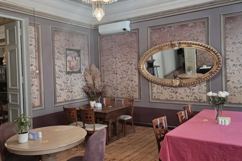 Dining room with ornate ceiling fresco and chandelier at Beletage Restaurant