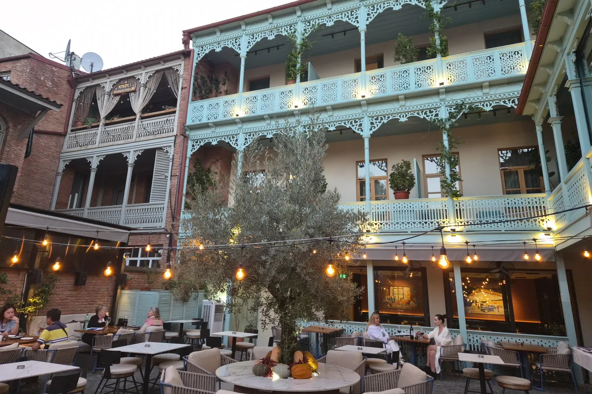 Courtyard patio with carved wooden balconies at The Blue Fox Restaurant