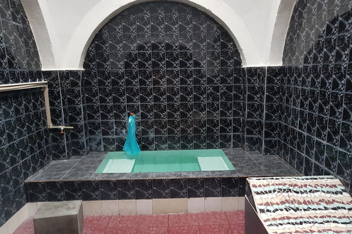 Private sulfur bath room with a tiled pool at Bohema