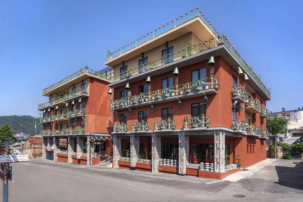 Brim Tbilisi's red brick facade with balconies on Abdushelishvili Street in Avlabari