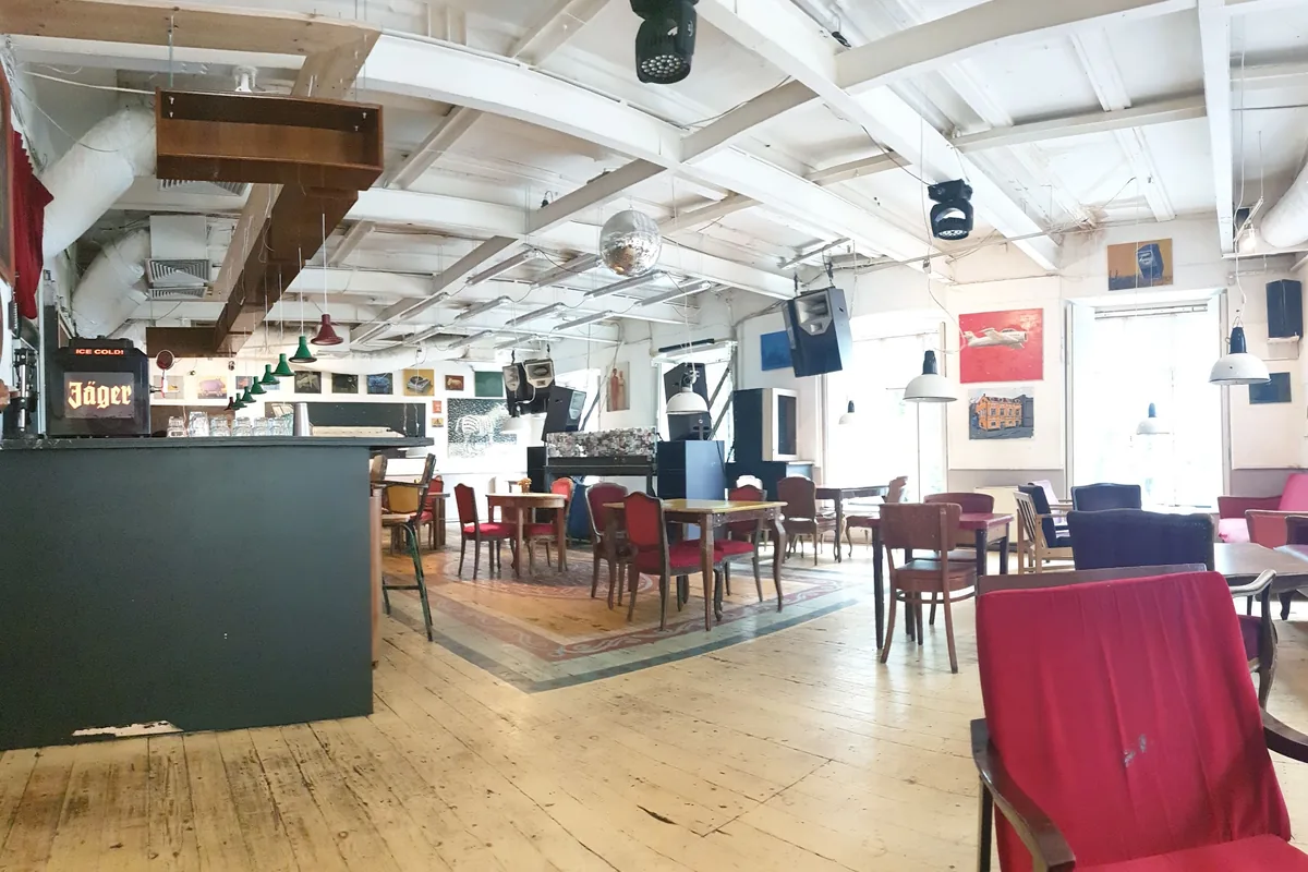 The wood-floored hall at Café Gallery, with its bar, DJ booth and disco ball