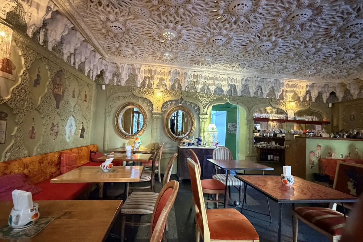 Painted ceiling, mirrors and red banquettes at Cafe Leila on Shavteli Street