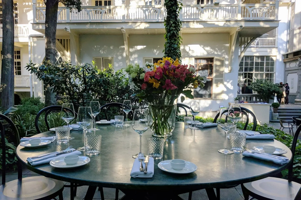 Garden table set for lunch in the courtyard of Cafe Littera