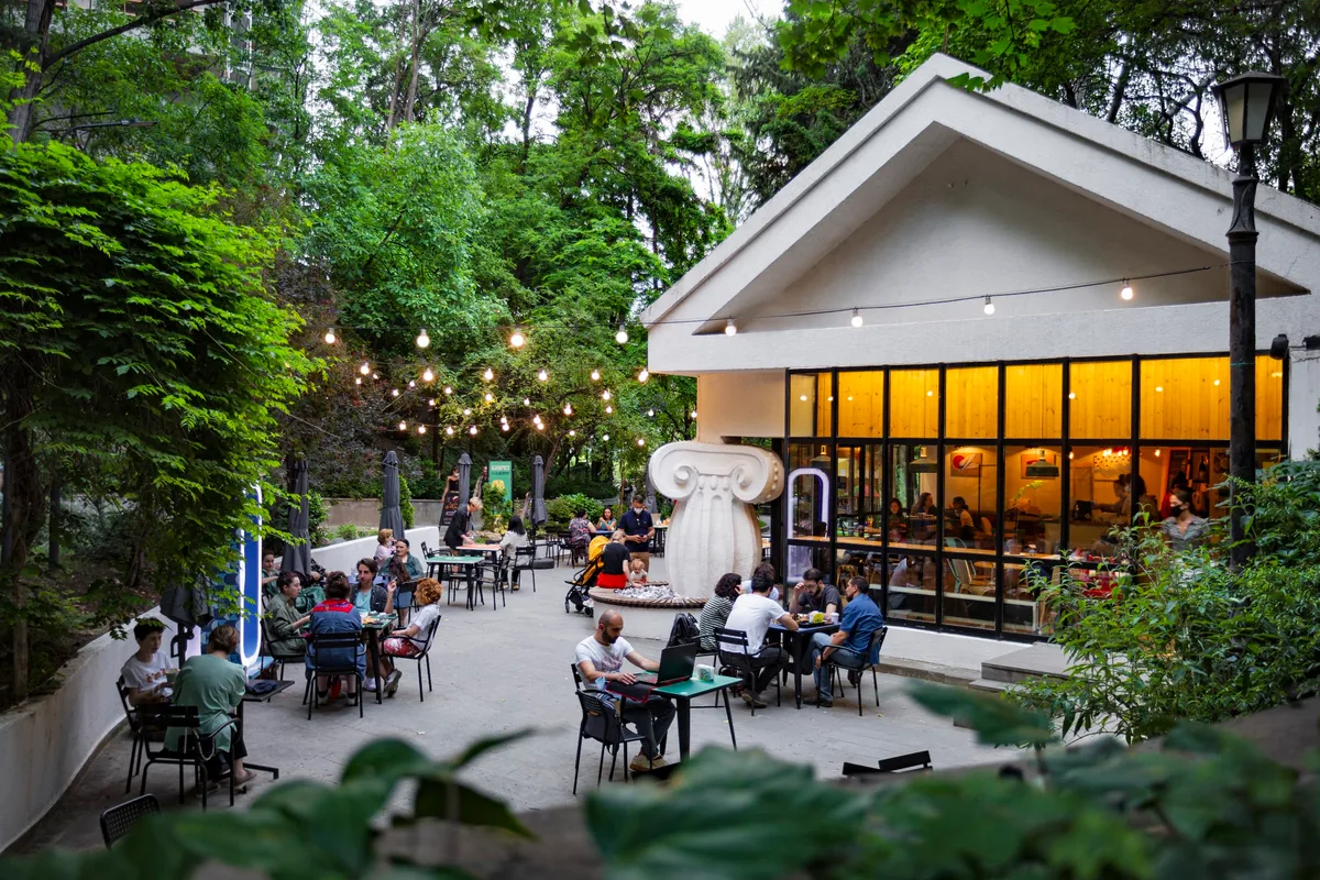 Outdoor courtyard seating beside park pavilion cafe at Cafe Mziuri