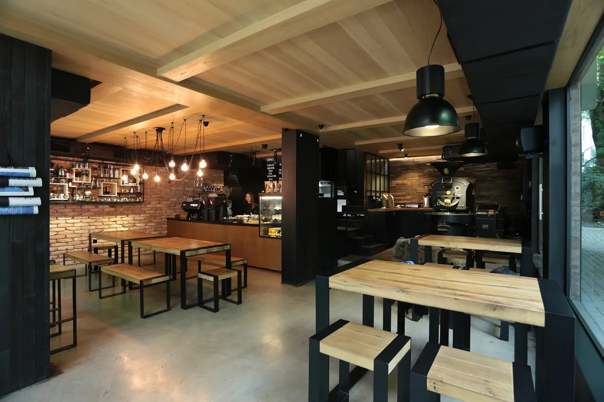 Wooden tables, the coffee bar and the roaster at Coffee LAB on Kazbegi Avenue in Saburtalo
