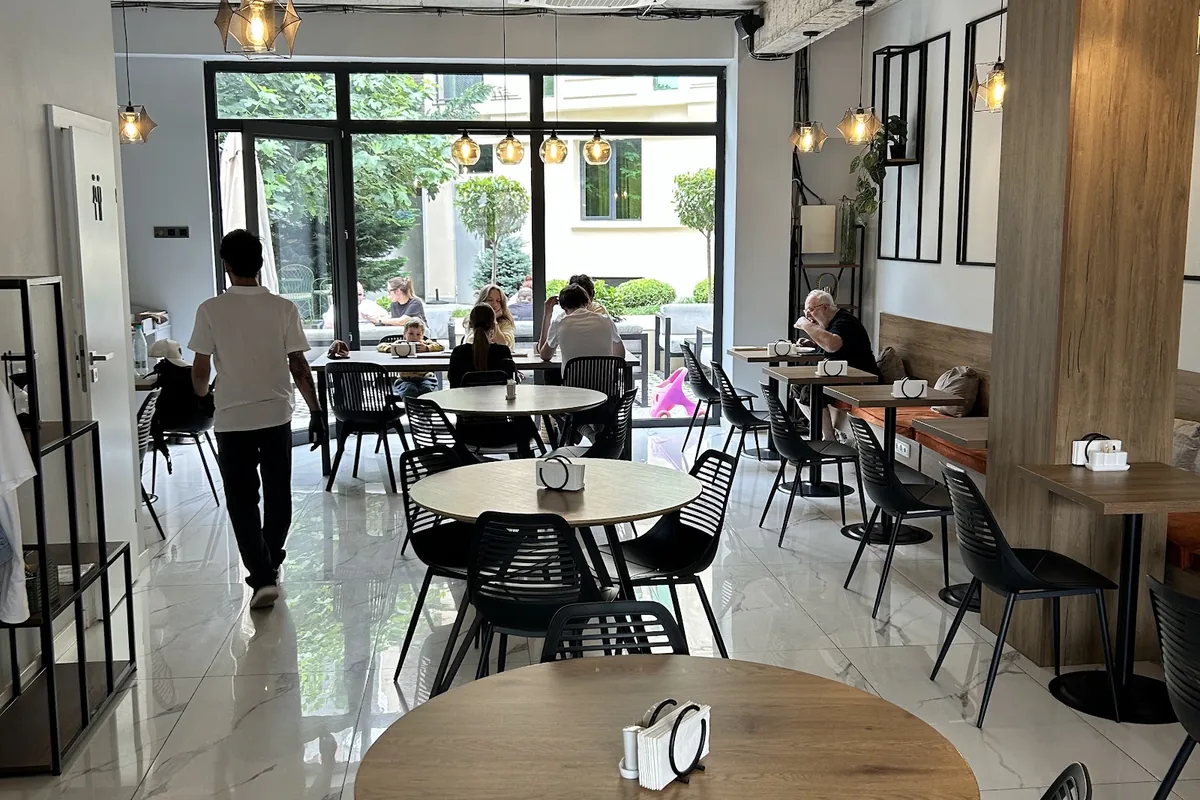 Bright dining room with round tables at Coffee Line in Avlabari