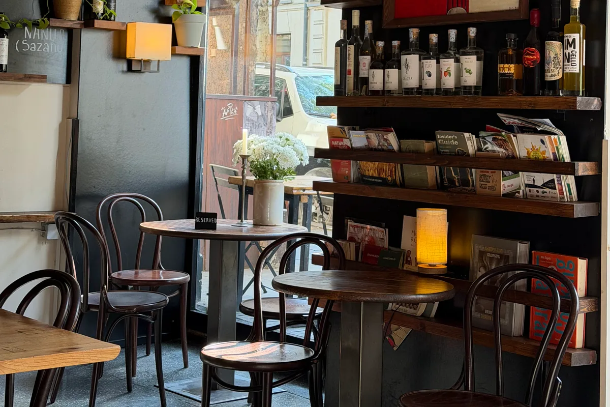 Wine bar interior with bottle shelves and wooden tables at DADI Wine Bar & Shop