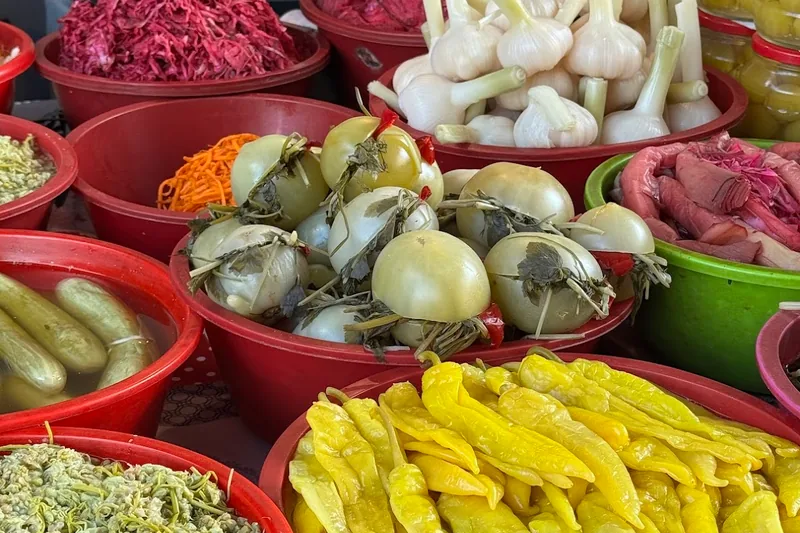 Assorted pickled vegetables in bowls and jars at a market stall at Dezerter Bazaar