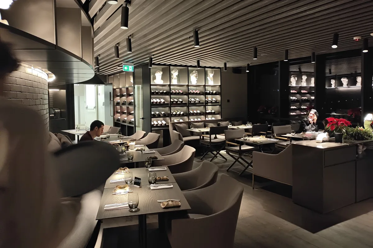 Modern upscale dining room with a wine display at Dumas in the Pullman Axis Towers
