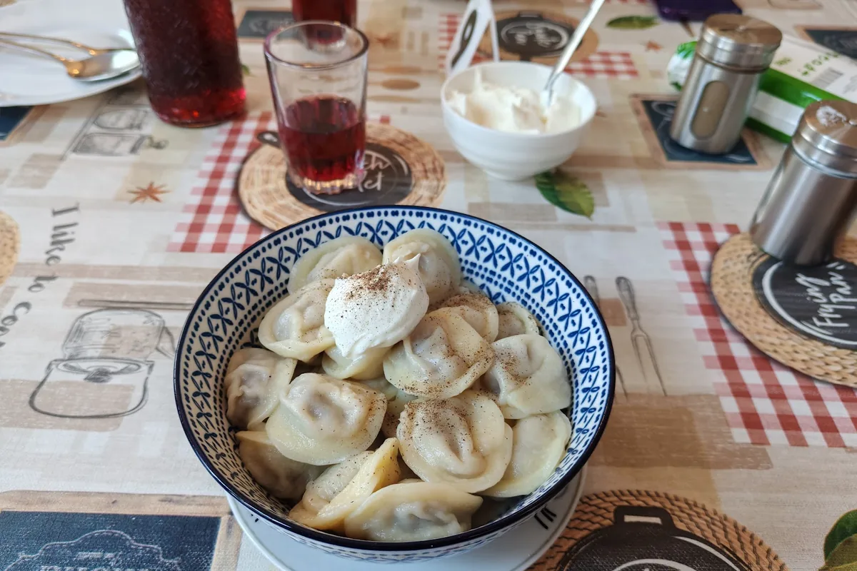 Bowl of pelmeni with sour cream at Dumplings N1