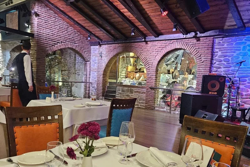 Dining room with brick archways and vaulted wooden ceiling at Ethno Tsiskvili