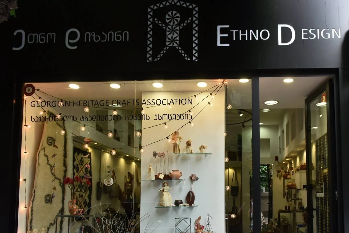 Shop window of Georgian crafts and felt rugs under the black Ethno Design sign at EthnoDesign