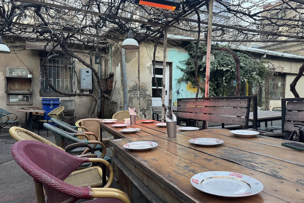 Courtyard tables under the vines at Sofia Melnikova's Fantastic Douqan