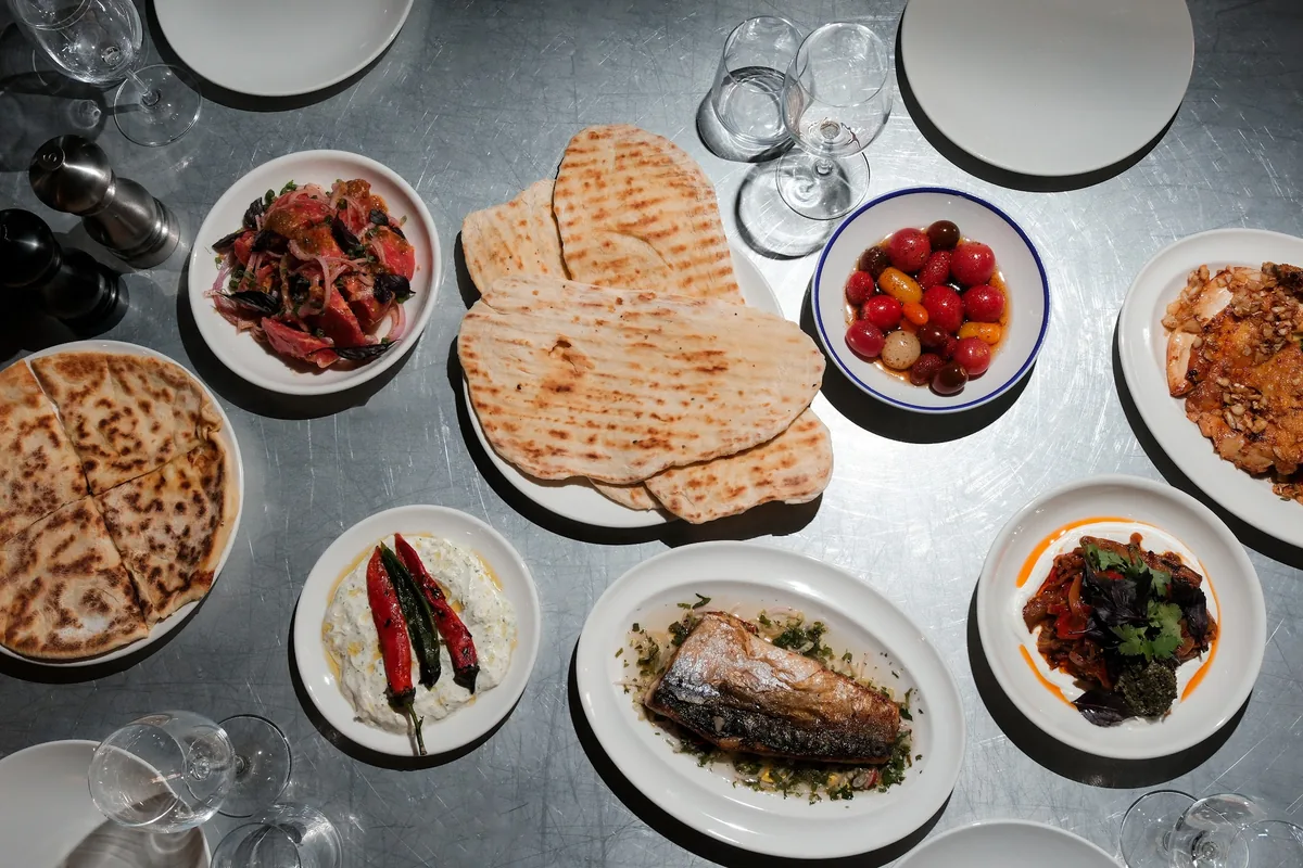 A table spread of flatbreads, grilled fish, salads and dips at FARM in Fabrika