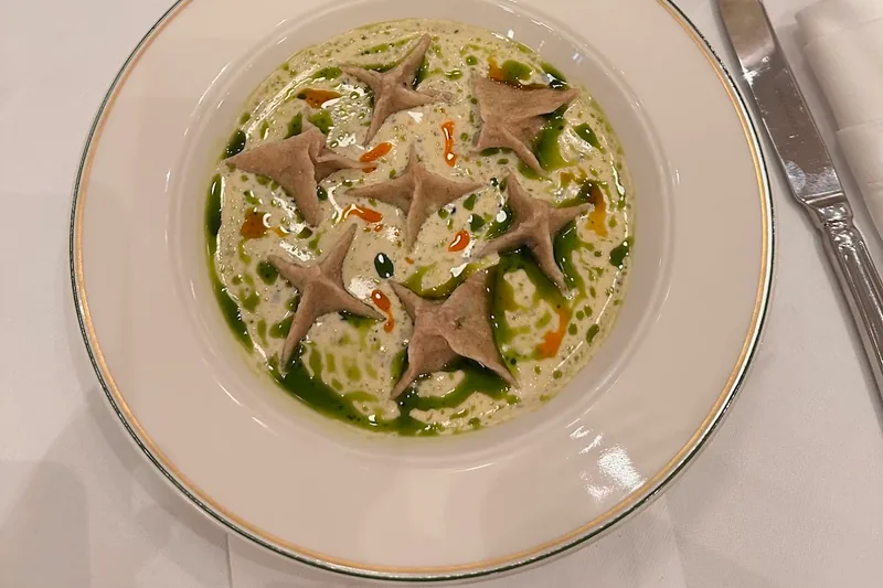 Pasta in creamy sauce garnished with herb oil at Grand Cafe
