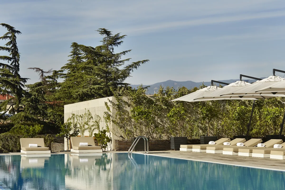 Outdoor pool and sun loungers at Holiday Inn Tbilisi