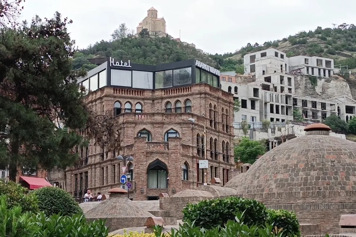 Hotel Abanotubani's brick building above the bath domes