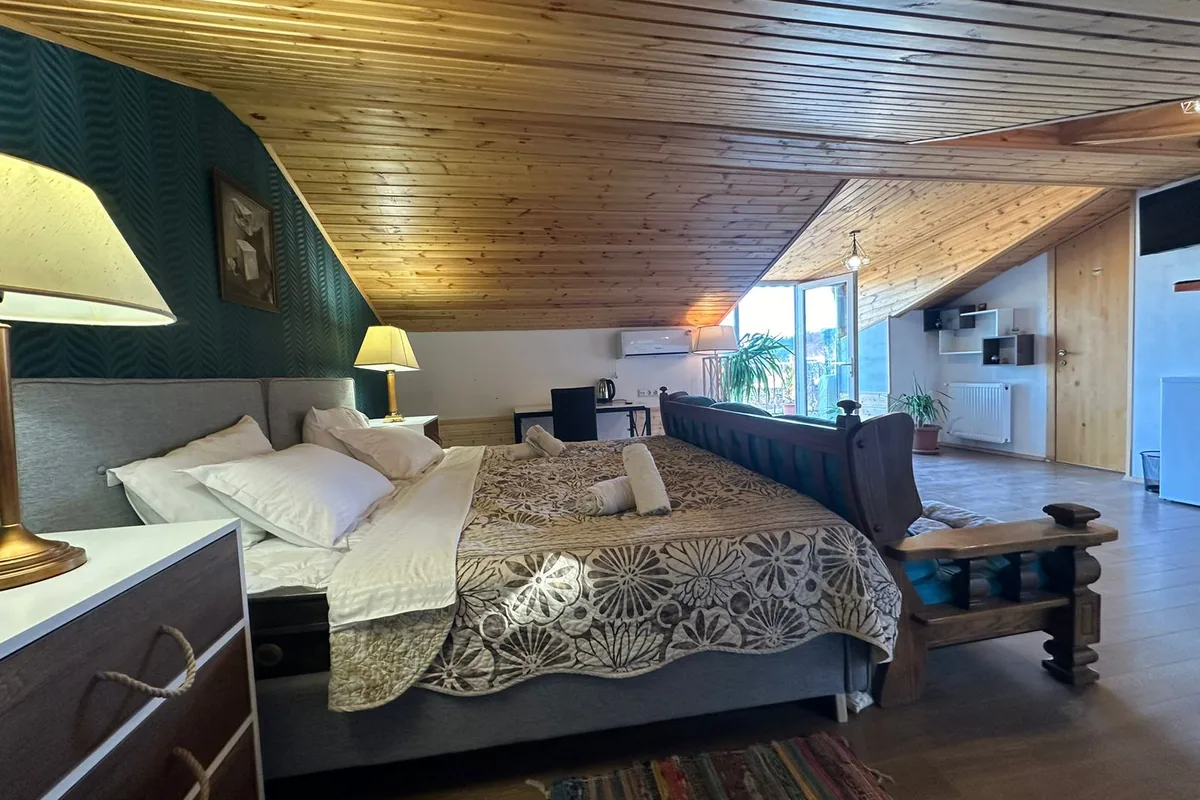 Double room under a wooden ceiling at Hotel Tbilisi Tales in Sololaki