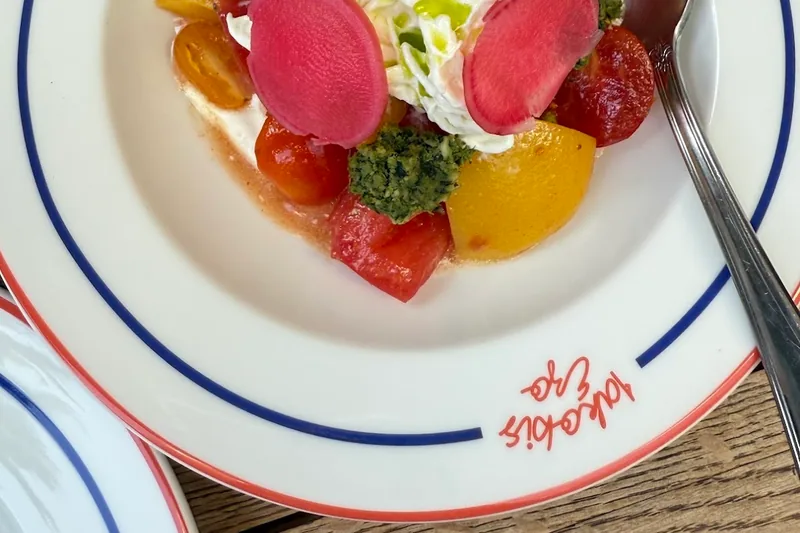Burrata salad with tomatoes, radishes, and pesto at Iakobis Ezo
