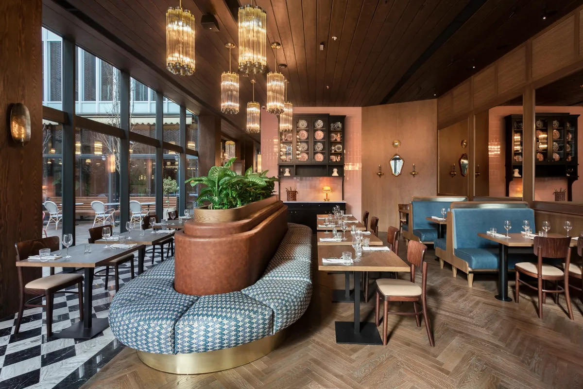 Dining room with curved banquette and glass chandeliers at Iakobis Ezo