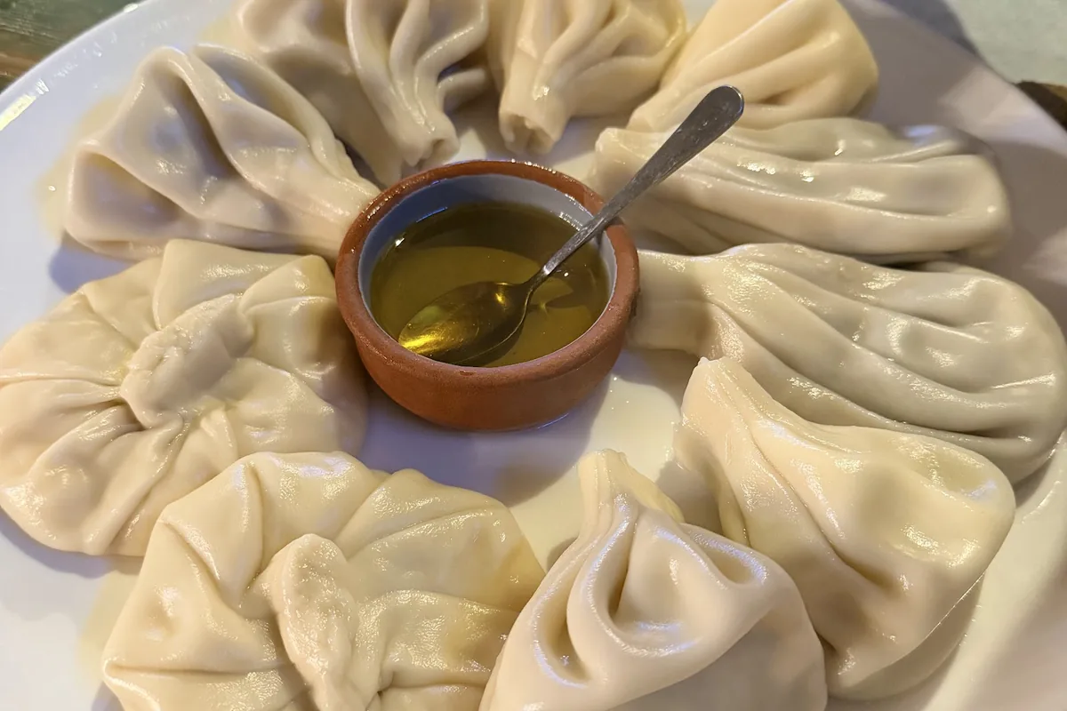 Khinkali around a pot of melted butter at Klike's Khinkali