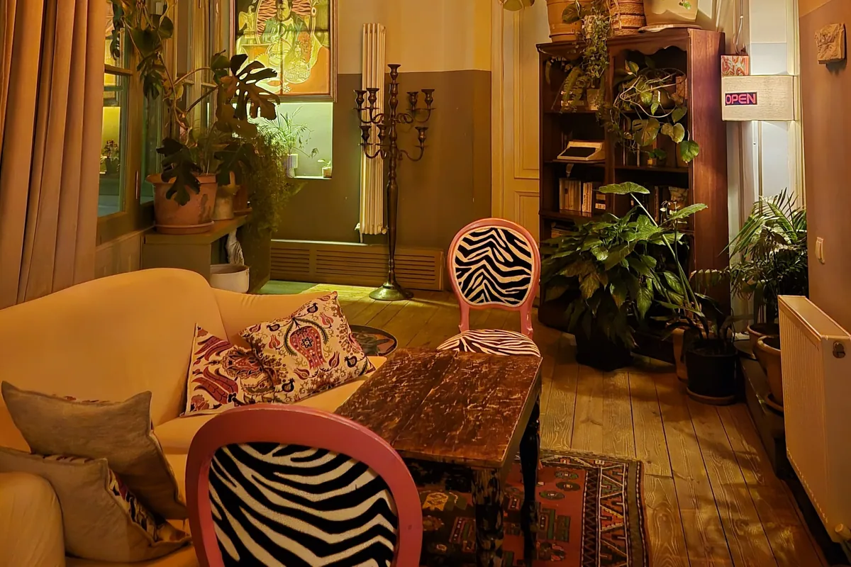 A sofa, zebra-print chairs and potted plants in the vintage room at L'ADO by Valiko Mansion