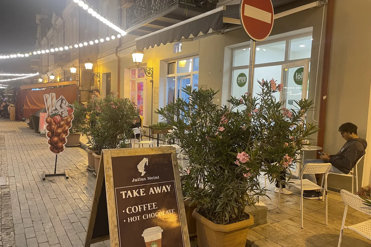 The shop front and terrace of a Lolly frozen yogurt branch at night