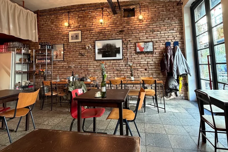 Exposed brick dining room with wooden tables at Londa