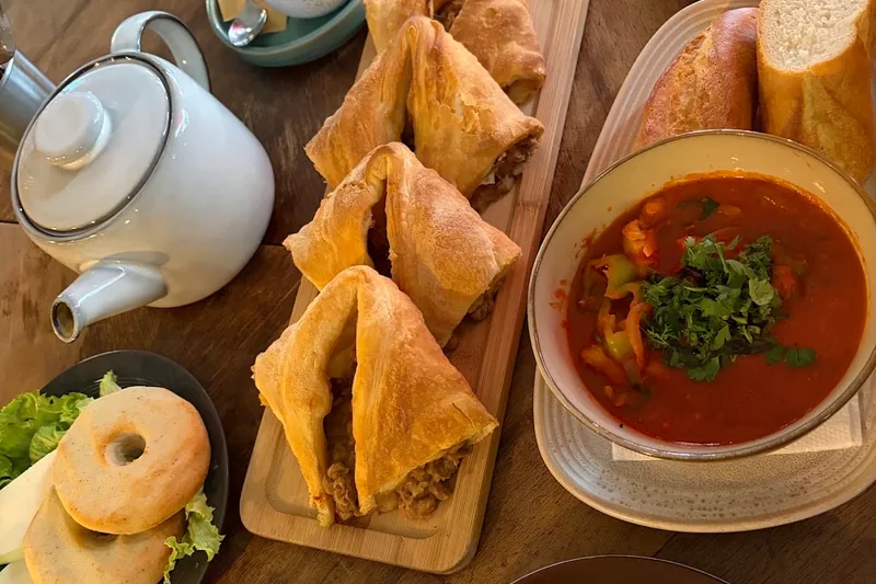 Puff pastry khachapuri, soup and bread on a table at Moulin Électrique