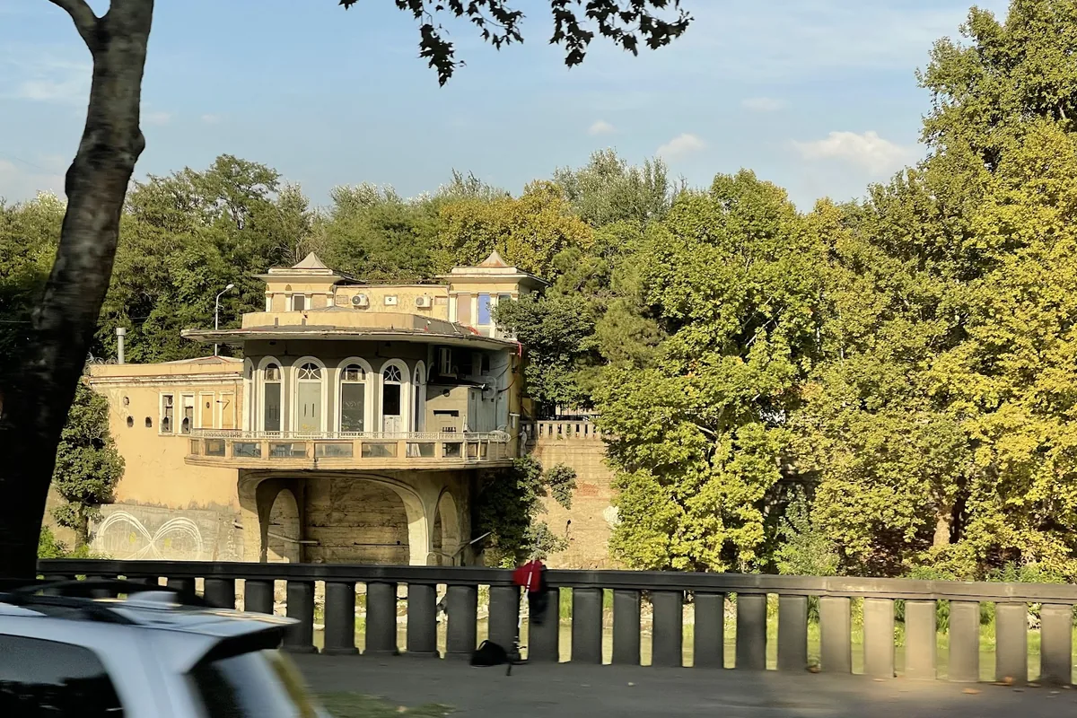 The glass-fronted former restaurant on the riverbank that houses Mtkvarze