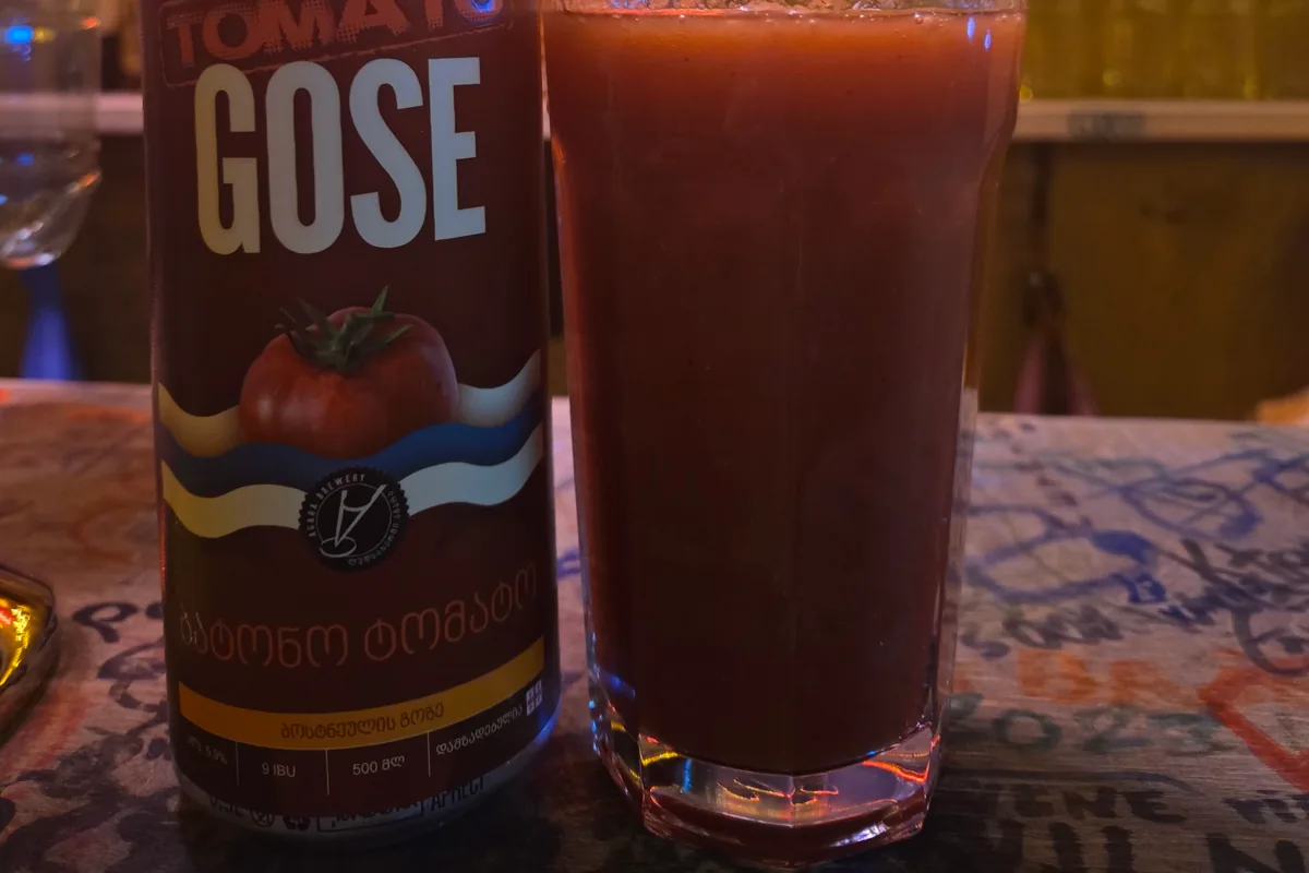 Tomato gose beer in a glass beside its can at Process Craft Beer Bar