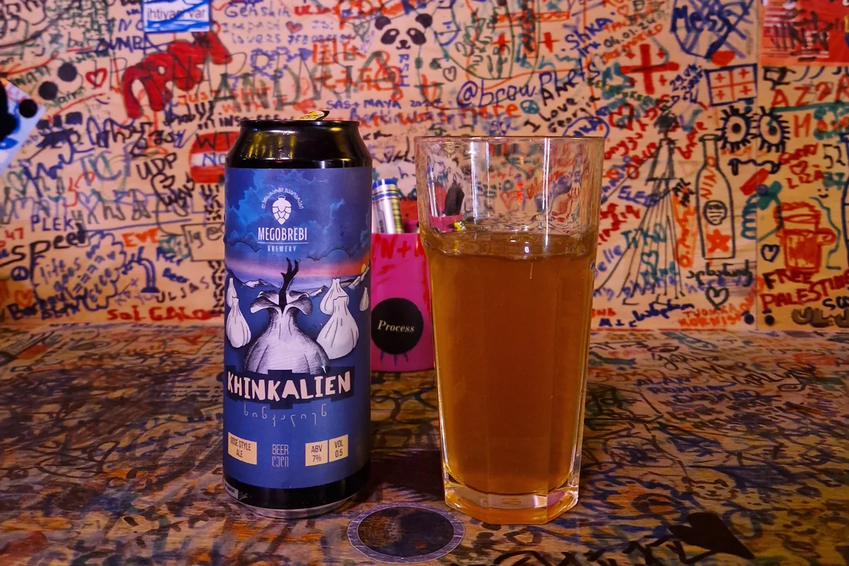 Can of Megobrebi Khinkalien gose, the beer spiced like khinkali, beside a full glass at Process Craft Beer Bar