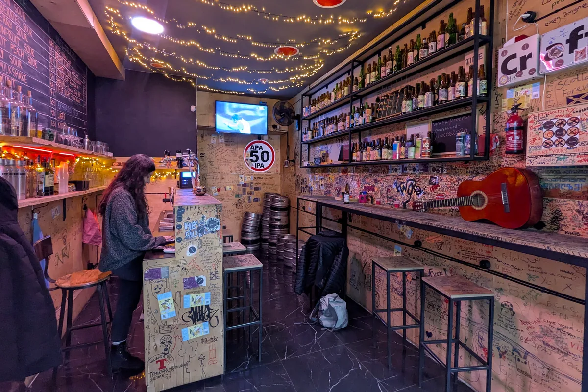 Cozy taproom with fairy lights and a guitar at Process Craft Beer Bar