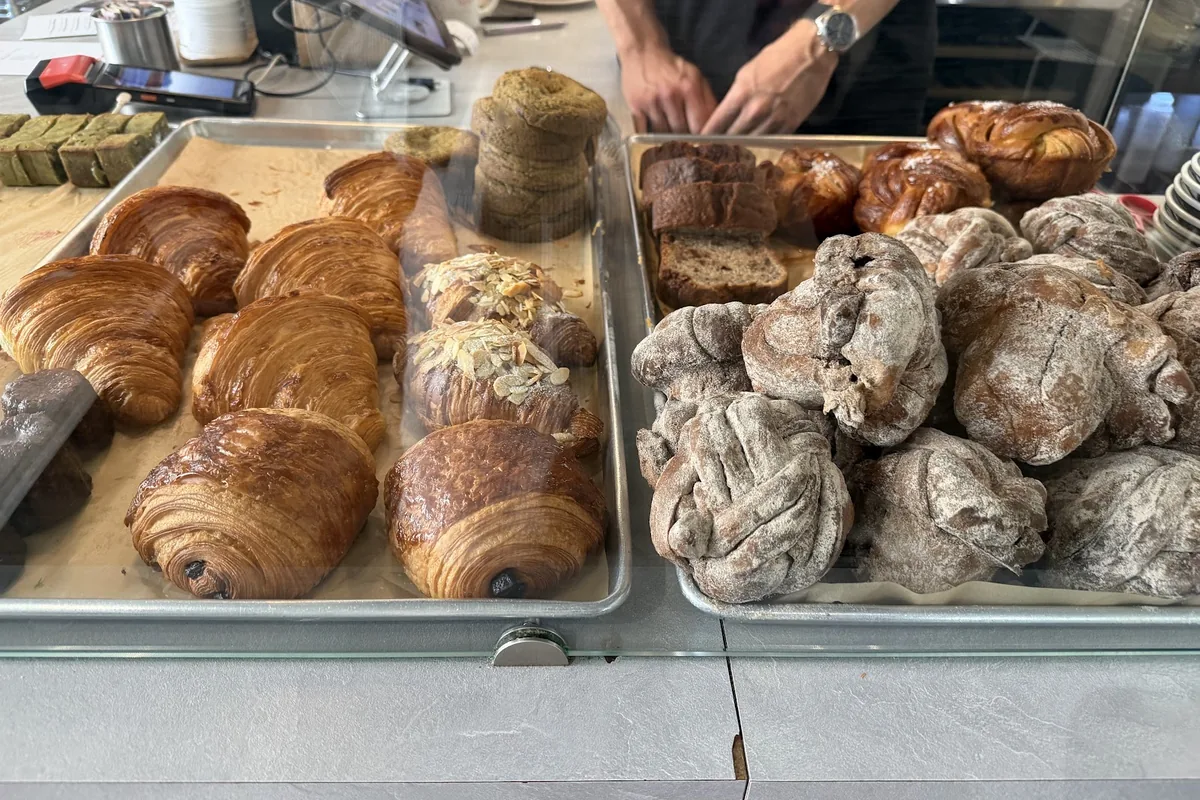 Croissants, pains au chocolat and sugar-dusted knotted buns on the counter at Pulp