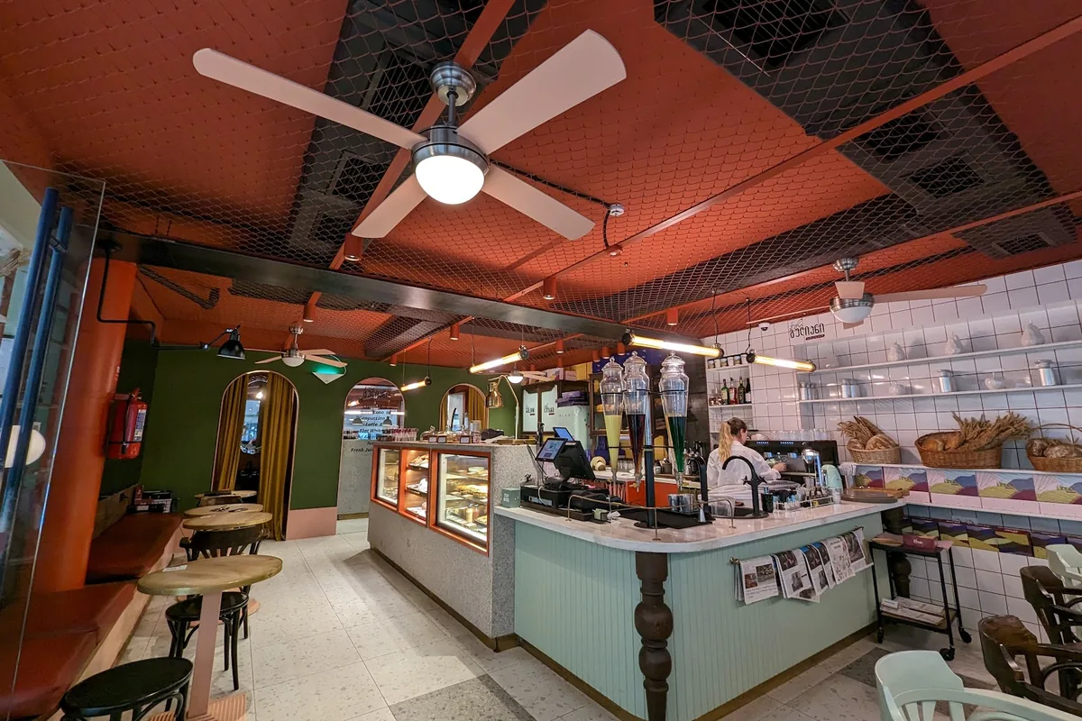 Orange ceiling, terrazzo floor and a mint-green counter at Puri Guliani Express on Abashidze Street