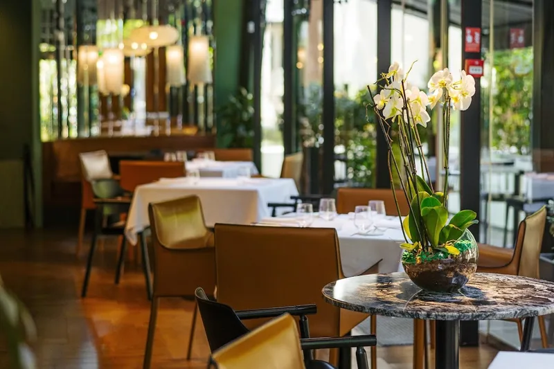 Dining room with floor-to-ceiling windows and orchid centerpiece at Reserve Restaurant