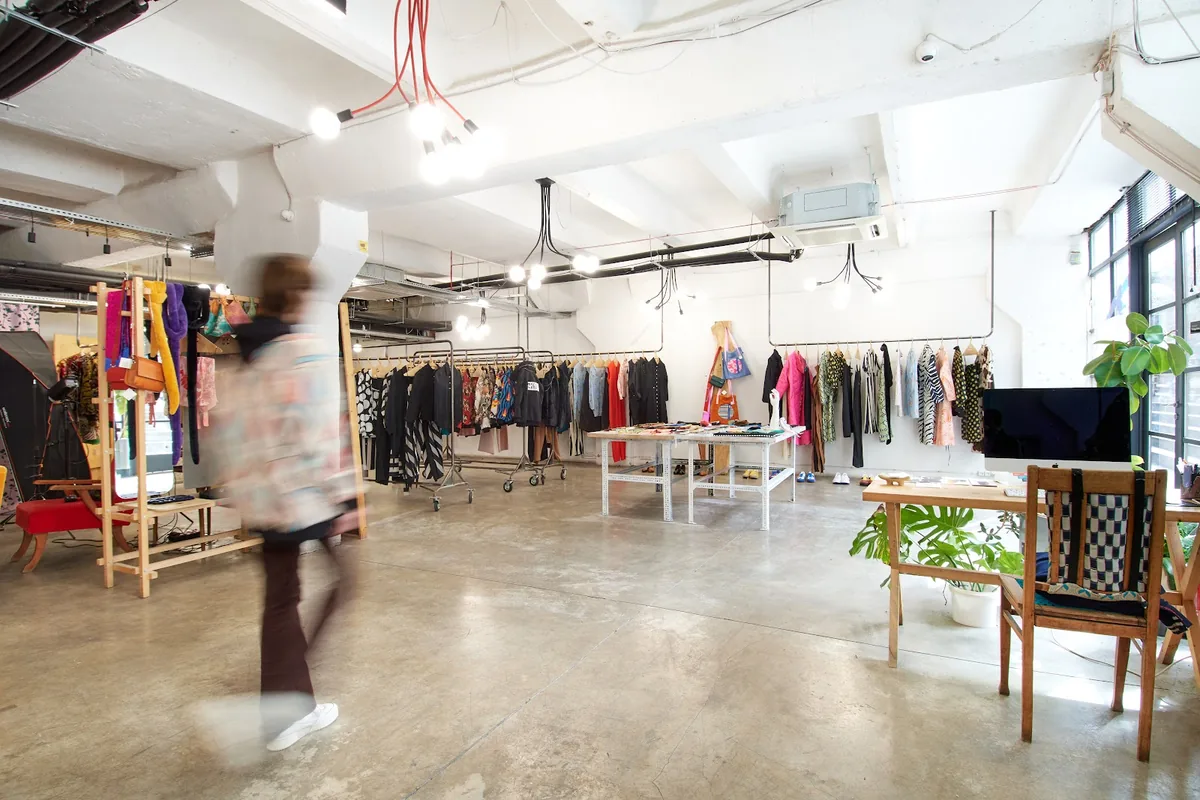 Clothing rails, display tables and hanging lights in the white-walled shop floor of Shavikata at Fabrika