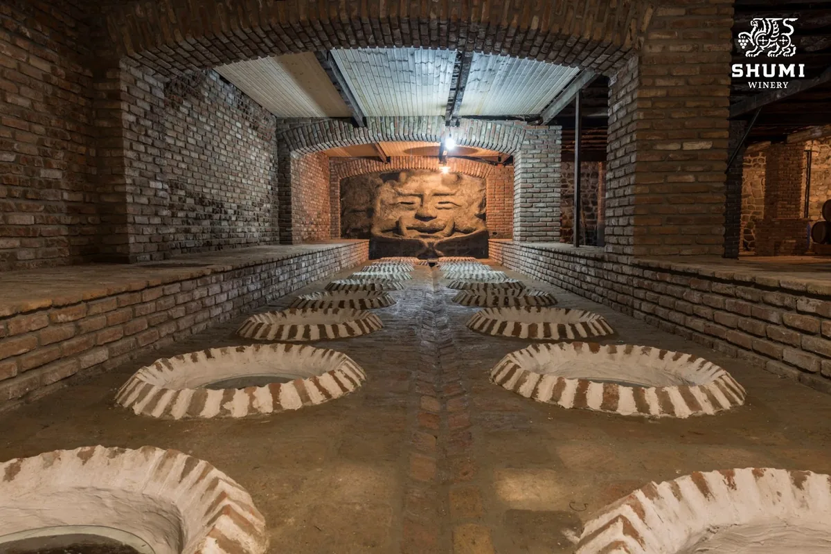Rows of qvevri rims set into the brick floor of the cellar at Shumi in Tsinandali