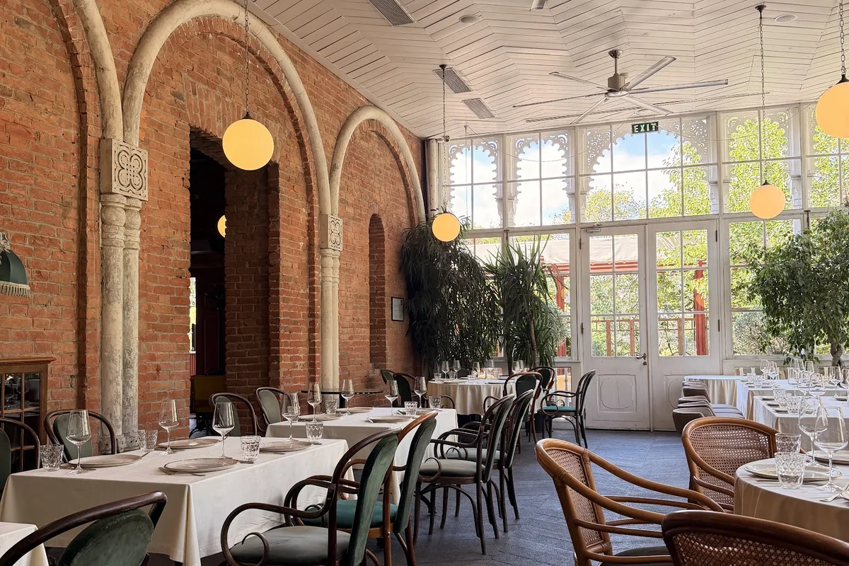 Dining room with brick arches and a carved white glass veranda at Shushabandi