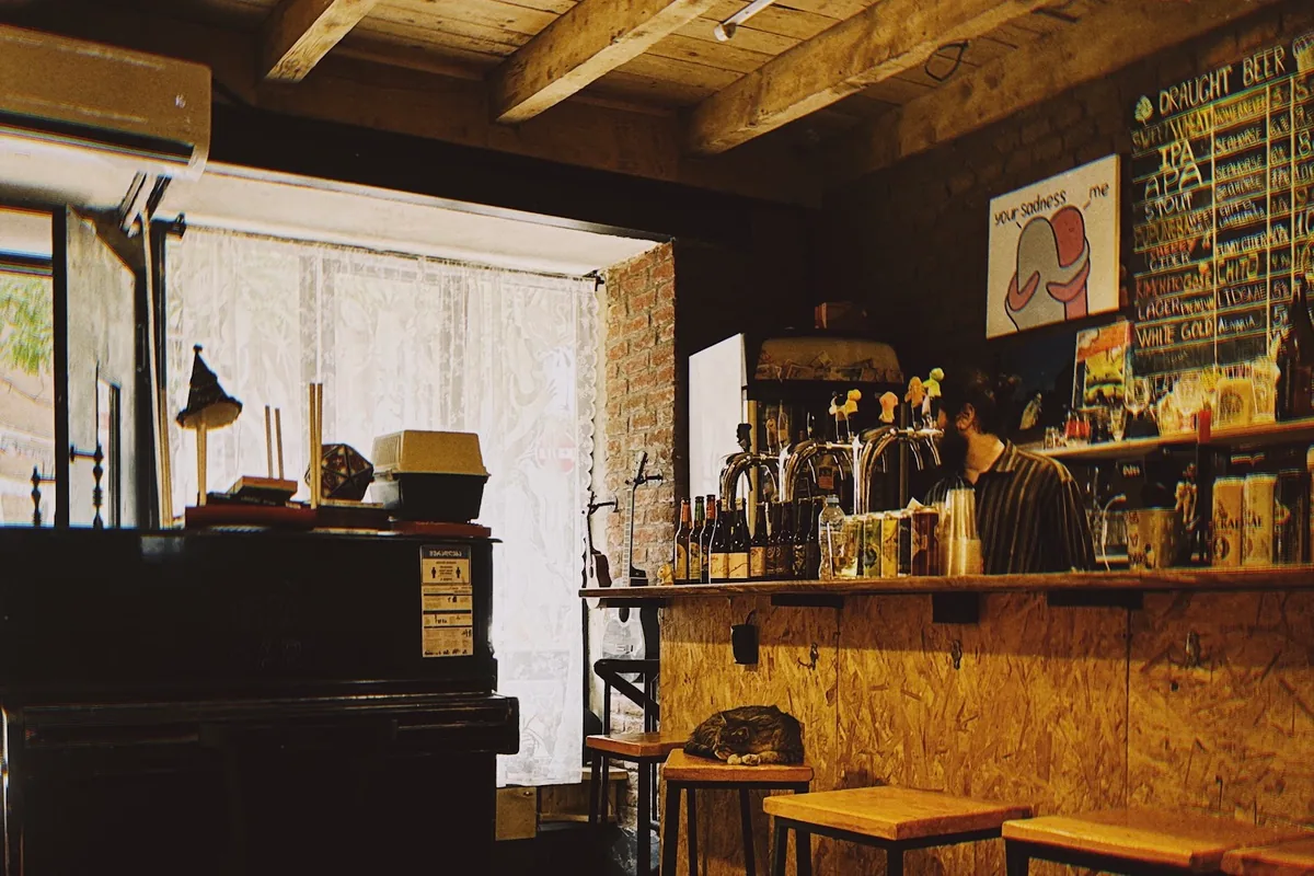 Wooden bar counter with beer taps and ceiling beams at Sma Craft Beer Bar