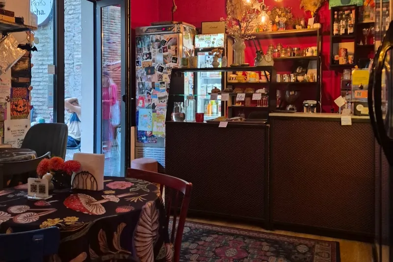 Cafe room with red walls and a counter at Stricha