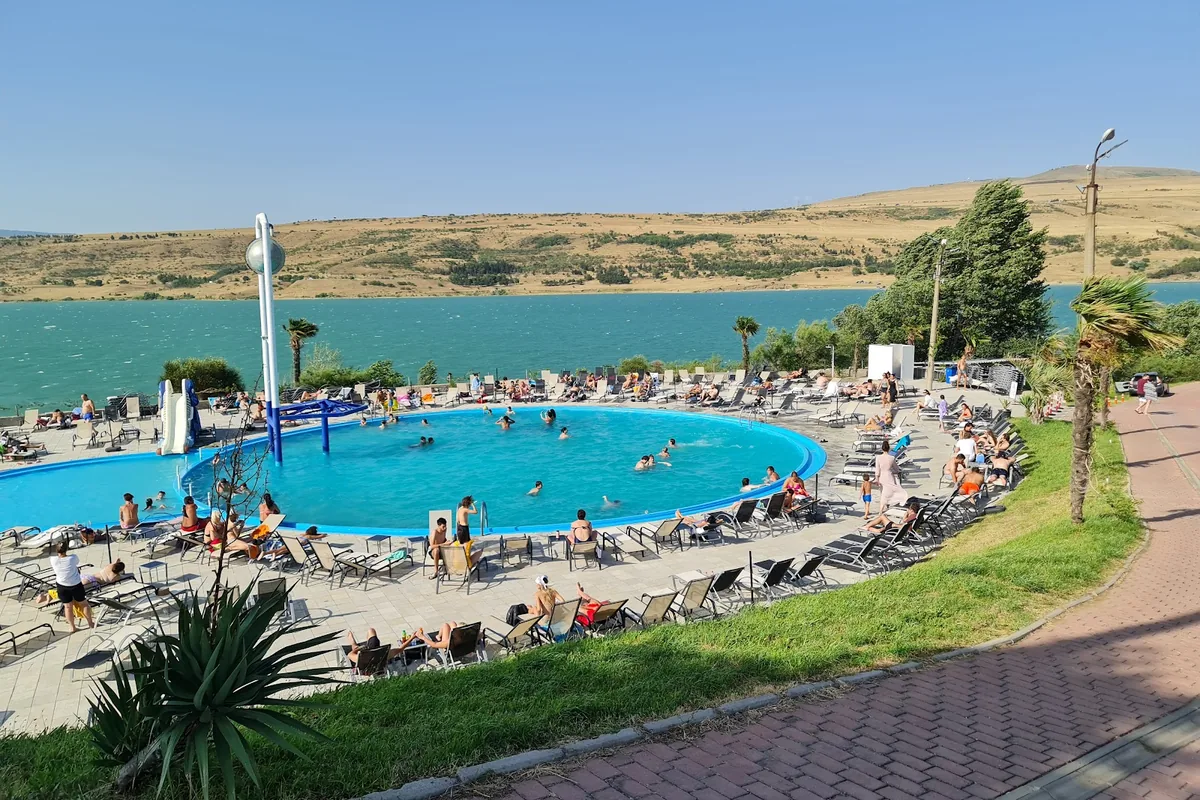Pool and sun loungers above the reservoir at Tbilisi Sea Club