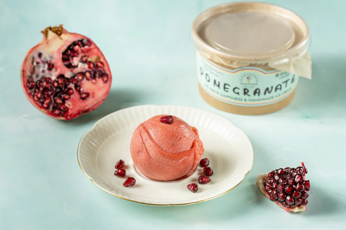 Pomegranate gelato scoop on a small plate at The Cone Culture