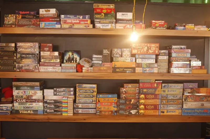 Shelves stacked with board games at Tsibakha Game Club