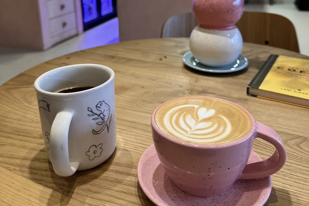 A mug of filter coffee and a cappuccino in a pink cup at Tsvari Roasters