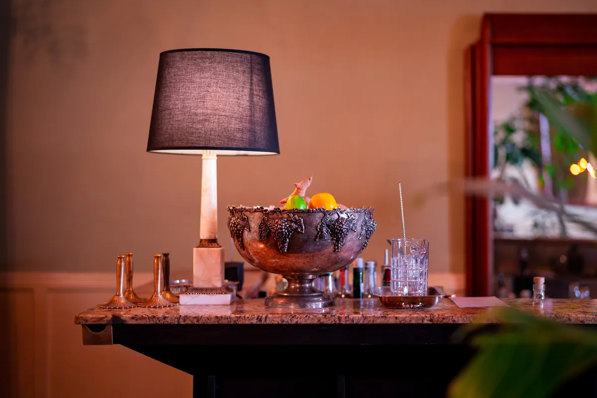 Marble bar counter with vintage lamp and champagne bowl at Weller