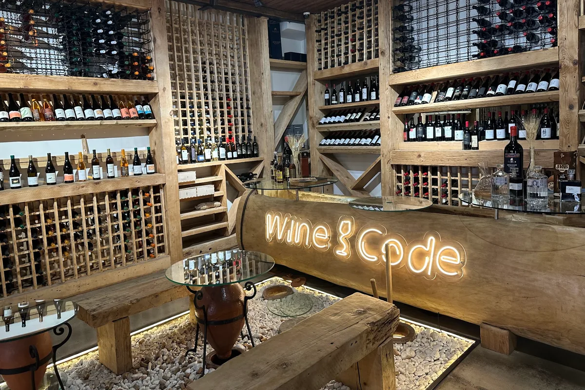 Tasting room with wine racks and glowing counter at WineCode